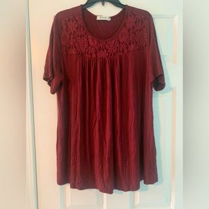 Burgundy colored top with lace on front